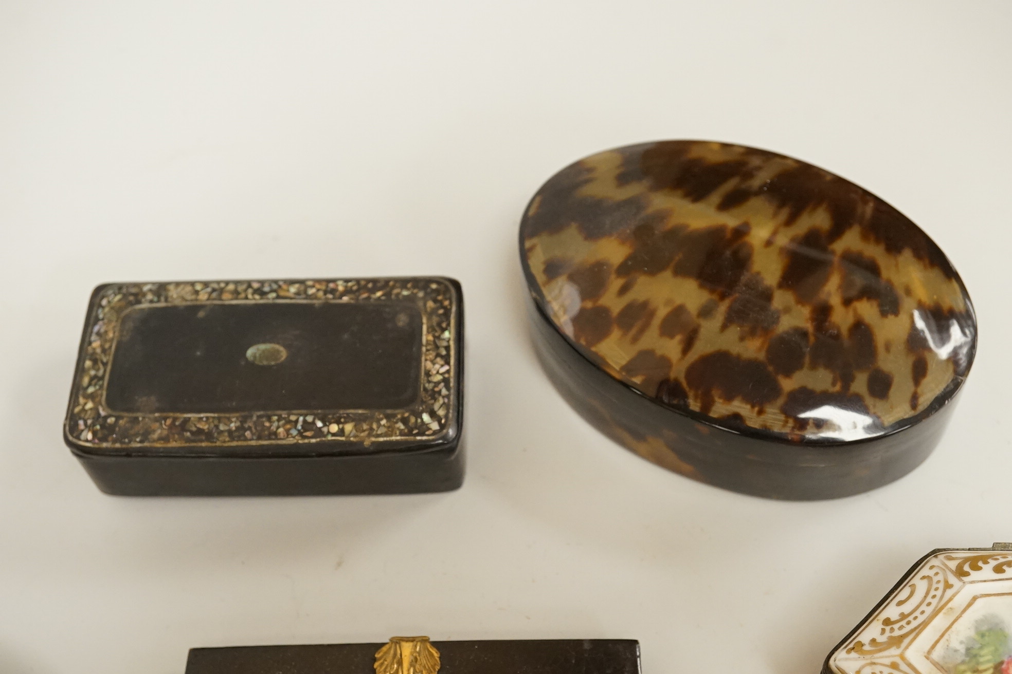 A collection of 19th century and later snuff and pill boxes, a silhouette frame and a gilt metal frame